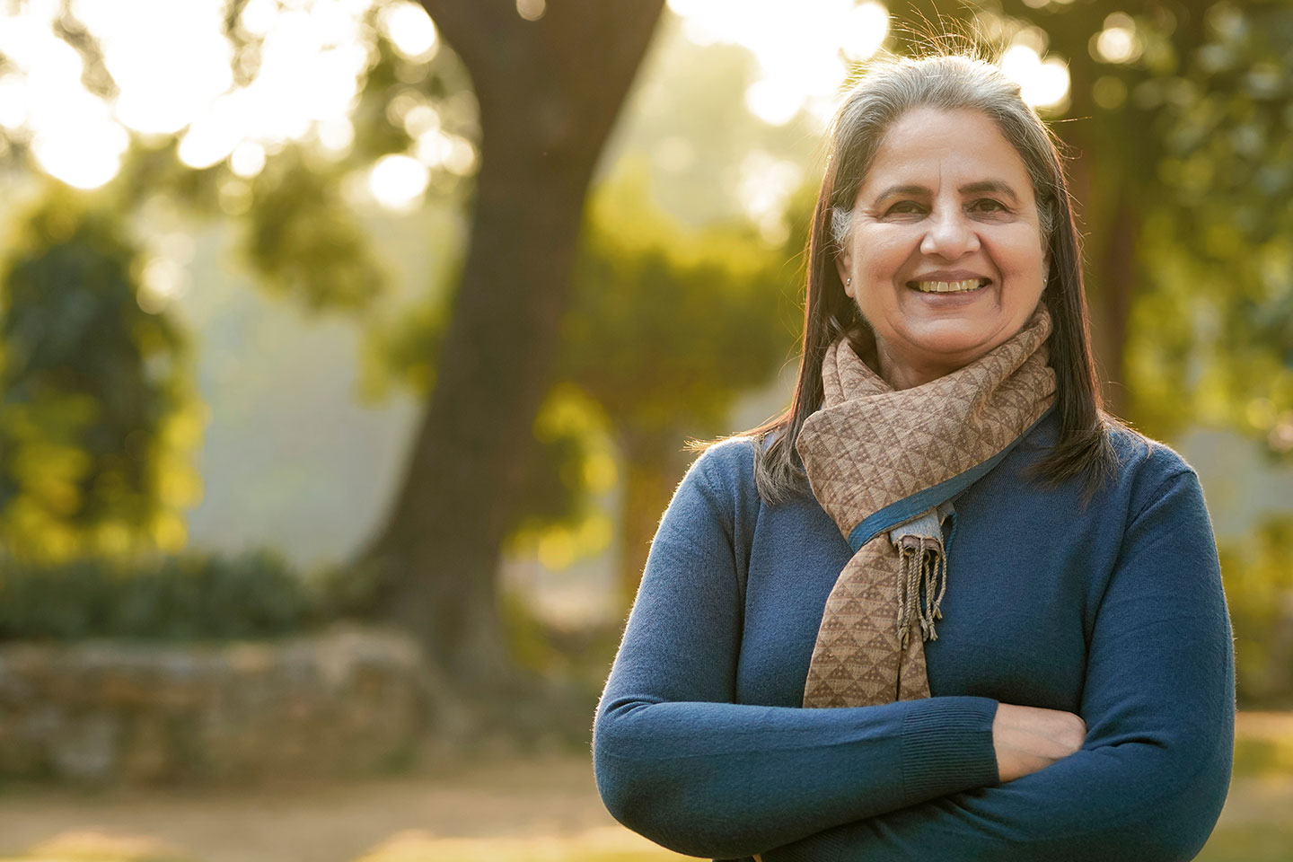 Photo of a woman in a patterned scarf smiling