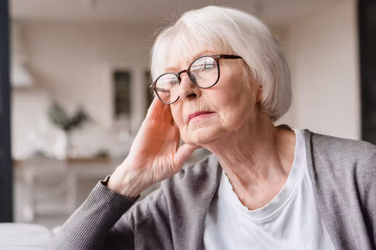 Photo of woman with glasses looking pensive