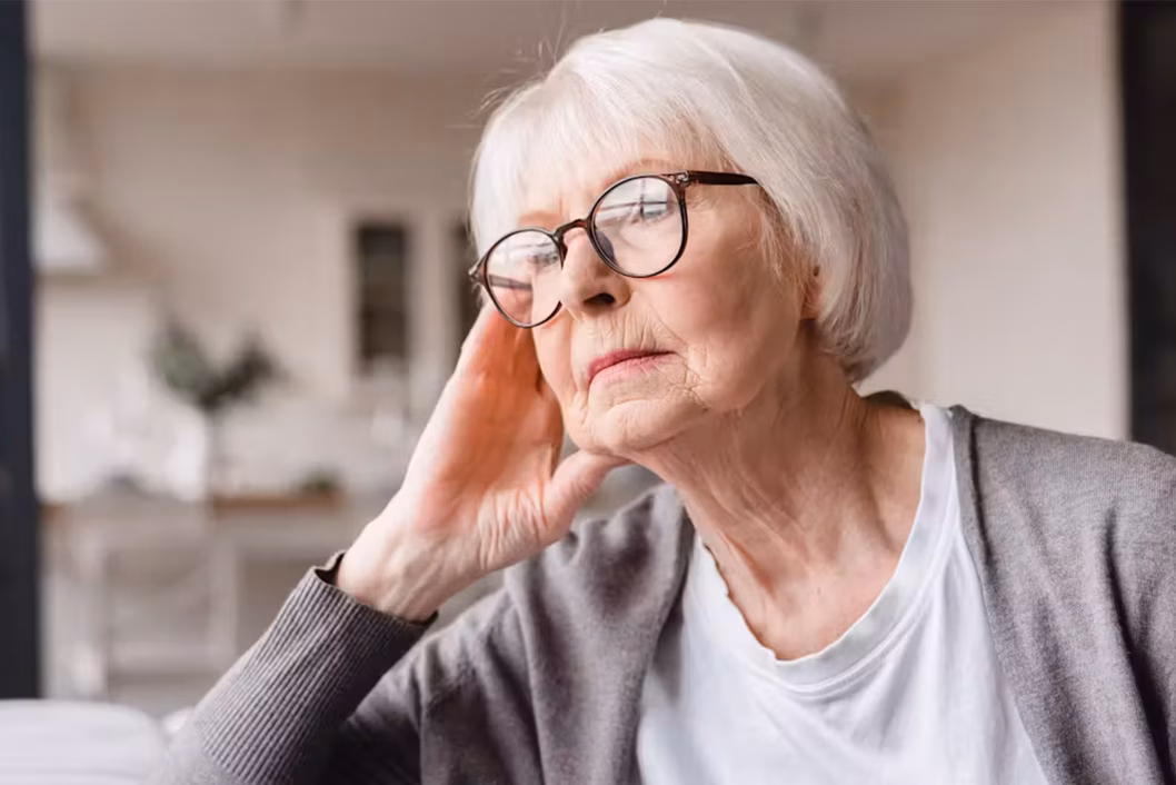 Photo of woman with glasses looking pensive