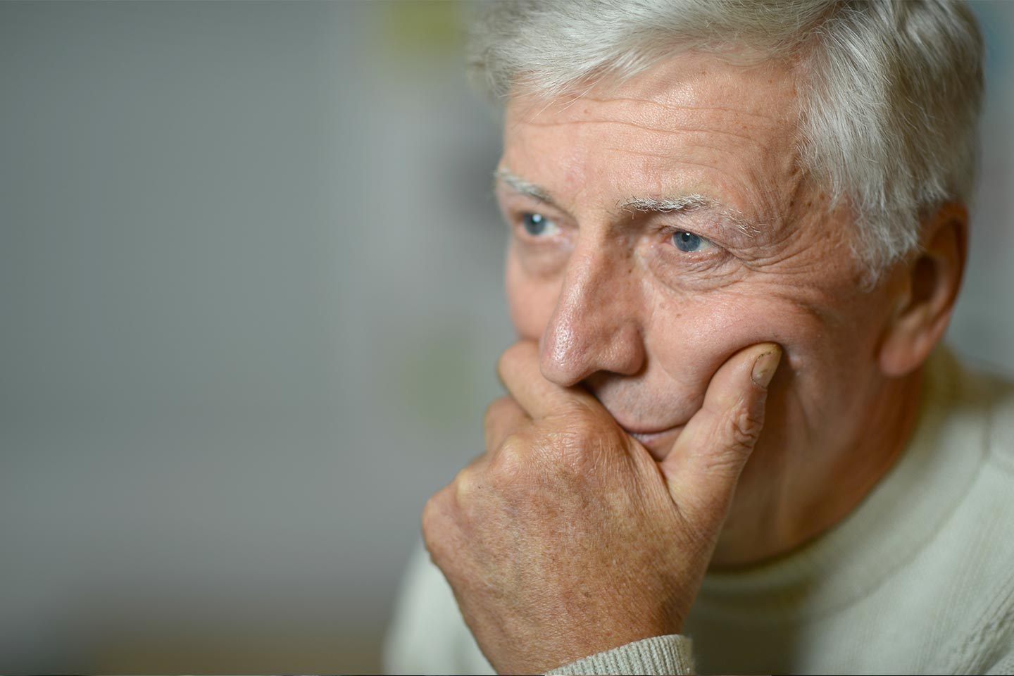 Photo of a man holding his chin in his hand