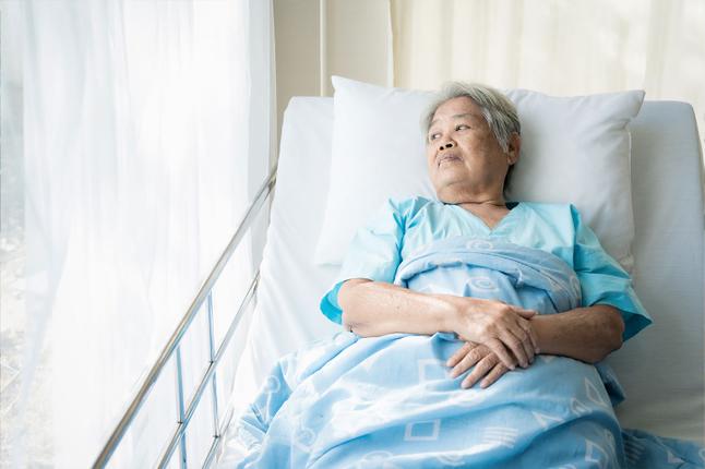 Photo of senior woman lying in a hospital bed