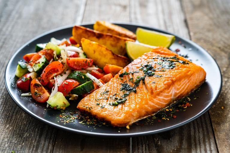 Plate of salmon, potatoes and salad