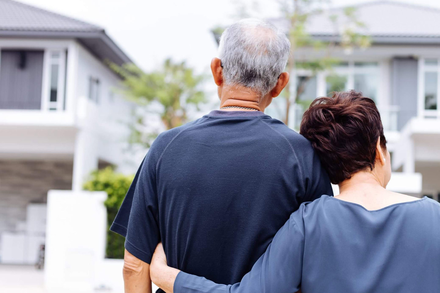 Photo of senior couple looking at homes