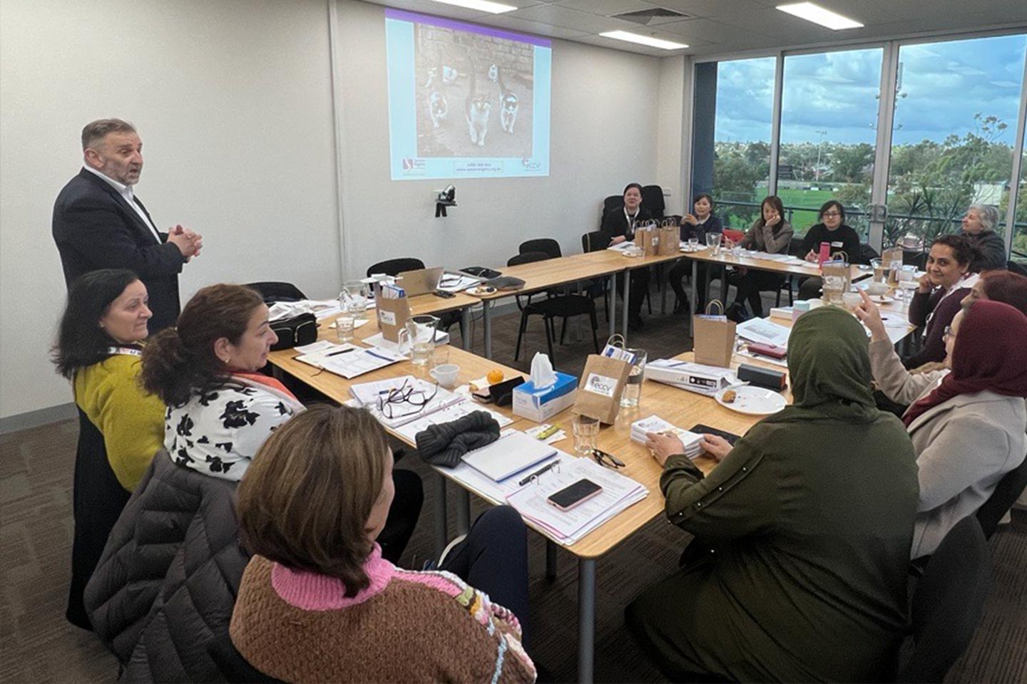 Photo of people sitting in a conference room meeting