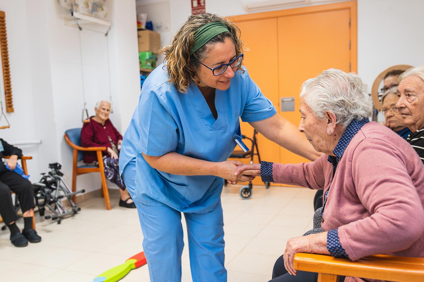 Photo of health worker helping a woman in a chair
