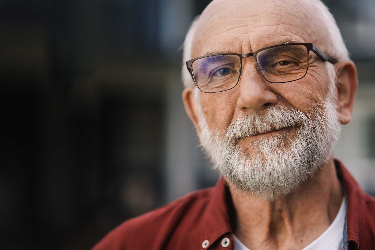 Image of an older bearded man wearing glasses