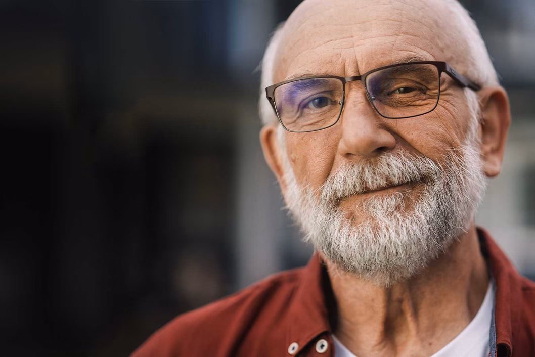 Image of an older bearded man wearing glasses
