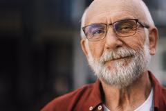 Image of an older bearded man wearing glasses