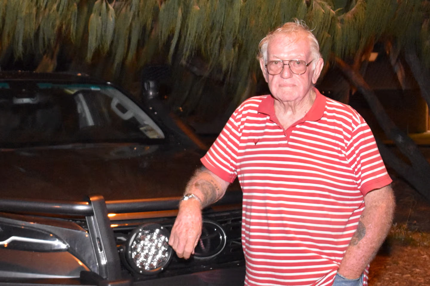 Photo of a man in a red and white striped polo