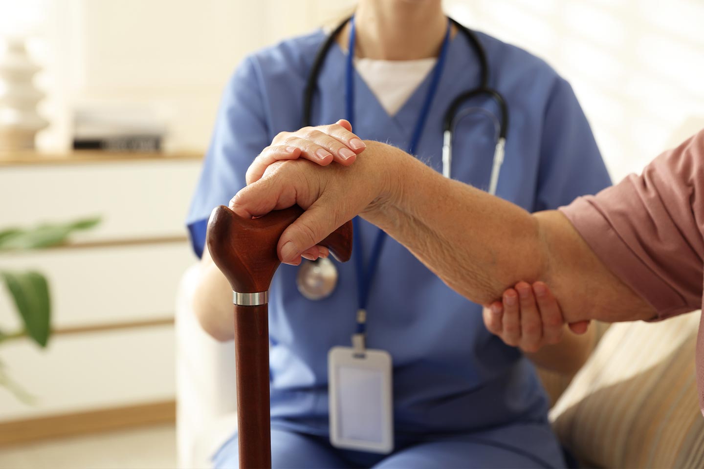 Photo of a health worker holding the arm of a patient