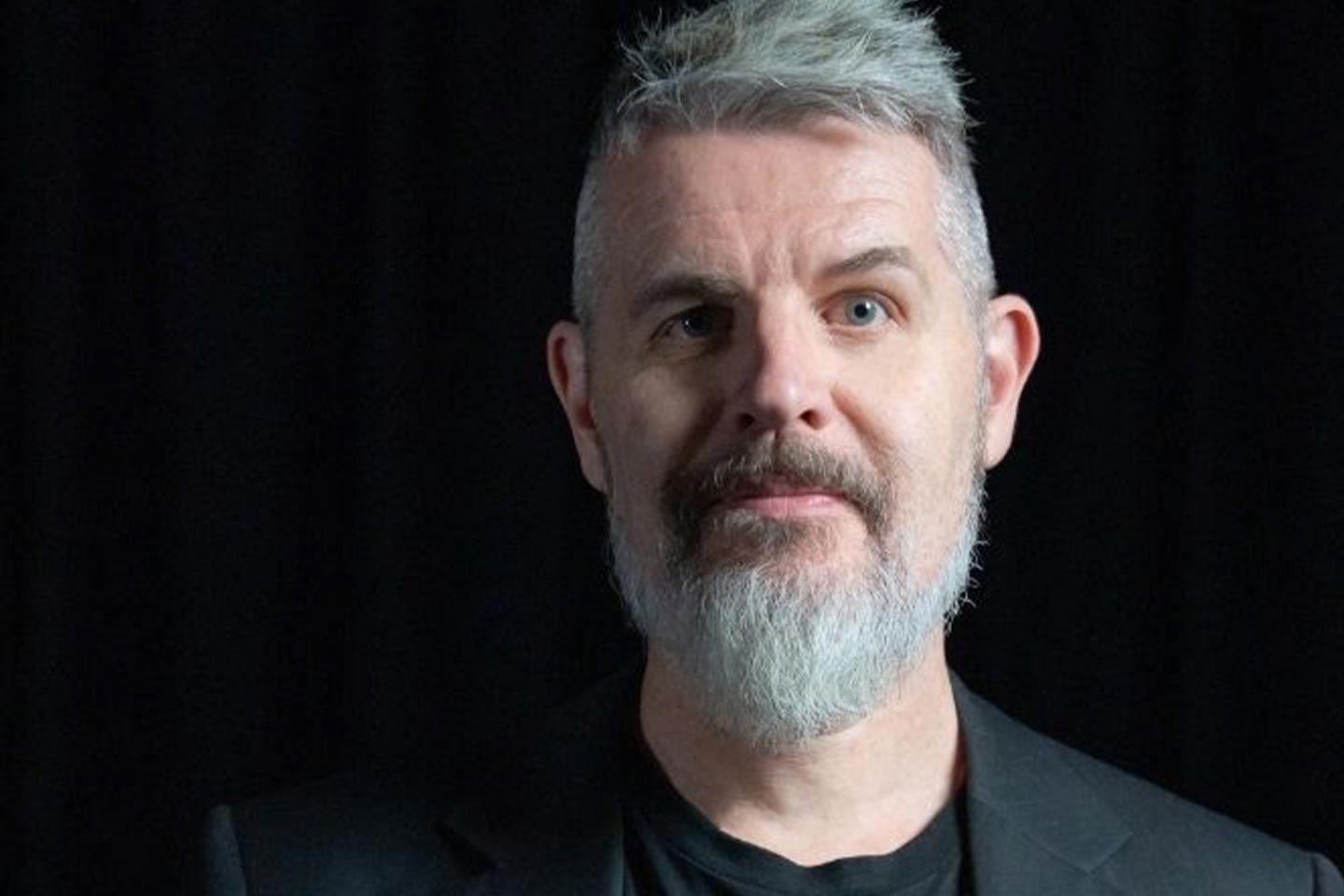 Photo of man with grey beard and hair