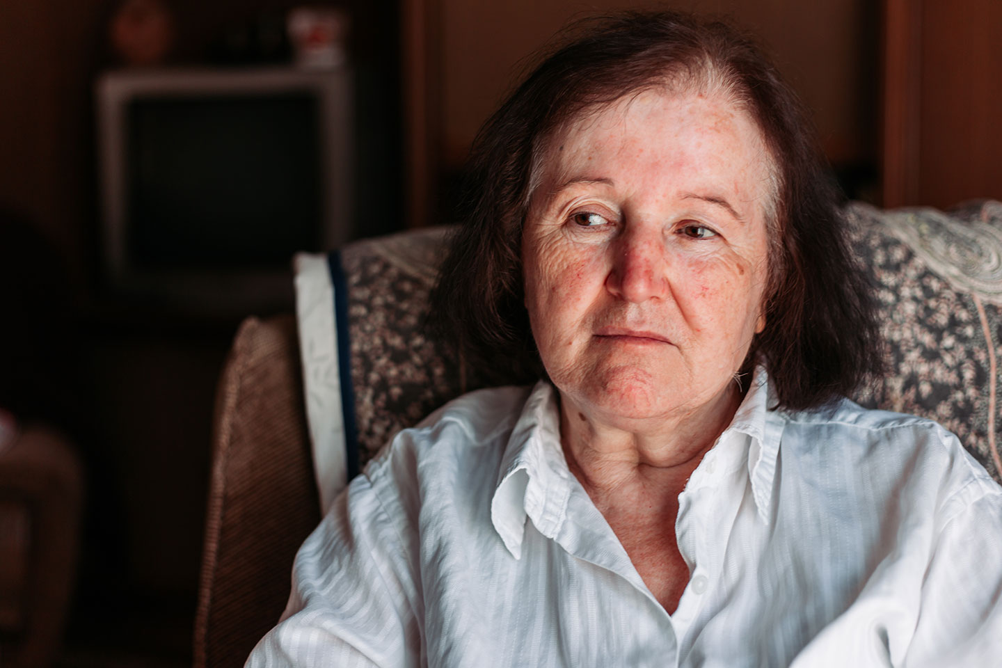 Image of an older woman sitting in a chair