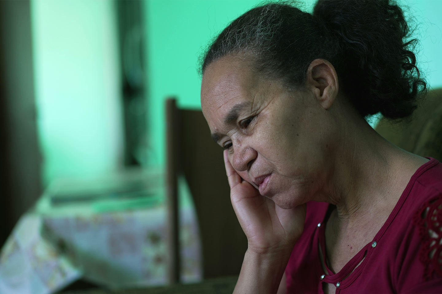 Photo of a woman resting her head in her hand