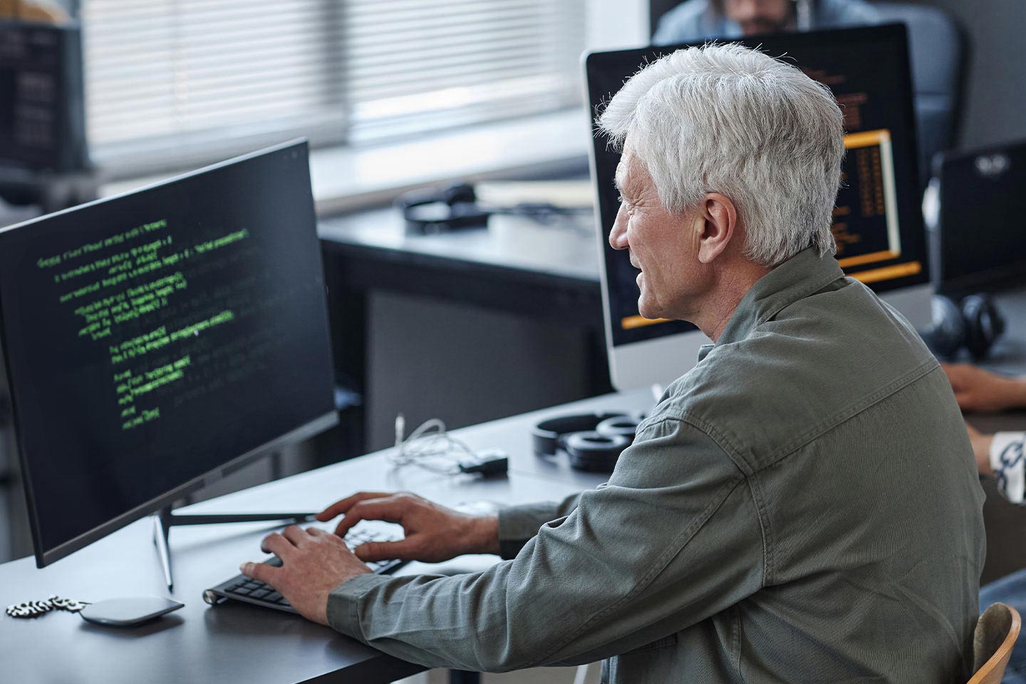 Photo of older man at computer desk