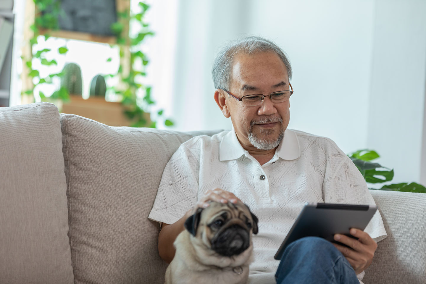 senior man using tablet device