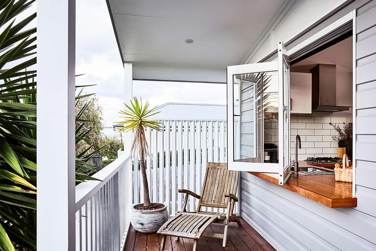 Image of a granny flat with a verandah and bi-fold windows opening onto a kitchen