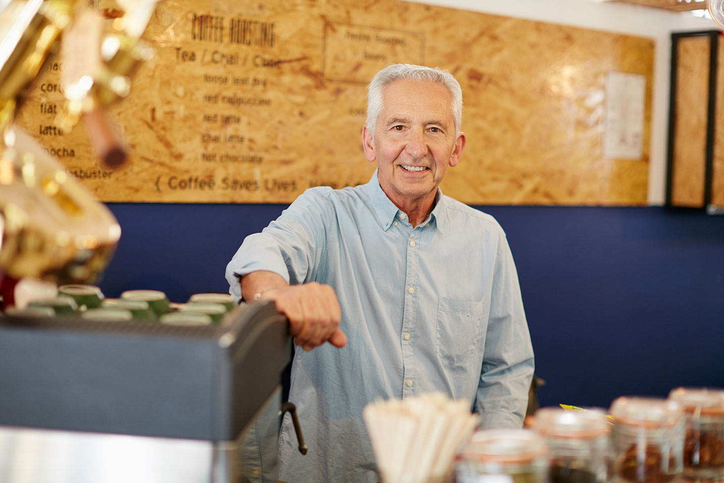 Image of an older man working in a cafe