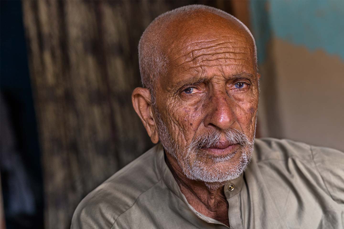Photo of man with a light beard and light khaki shirt