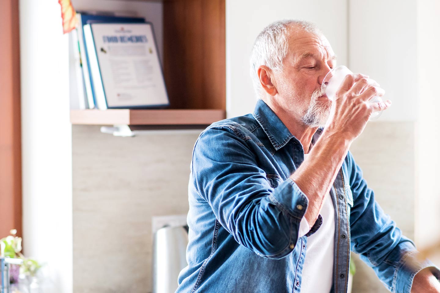 Photo of a man drinking a glass of water
