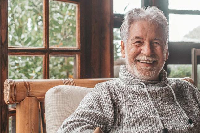 Photo of a smiling man in wearing a cosy grey knit