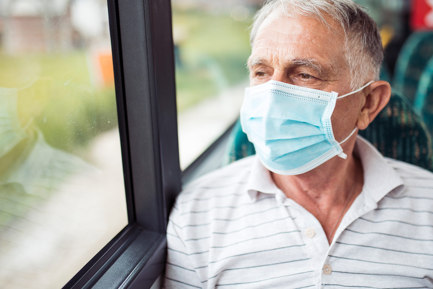 Man on public transport wearing a face mask