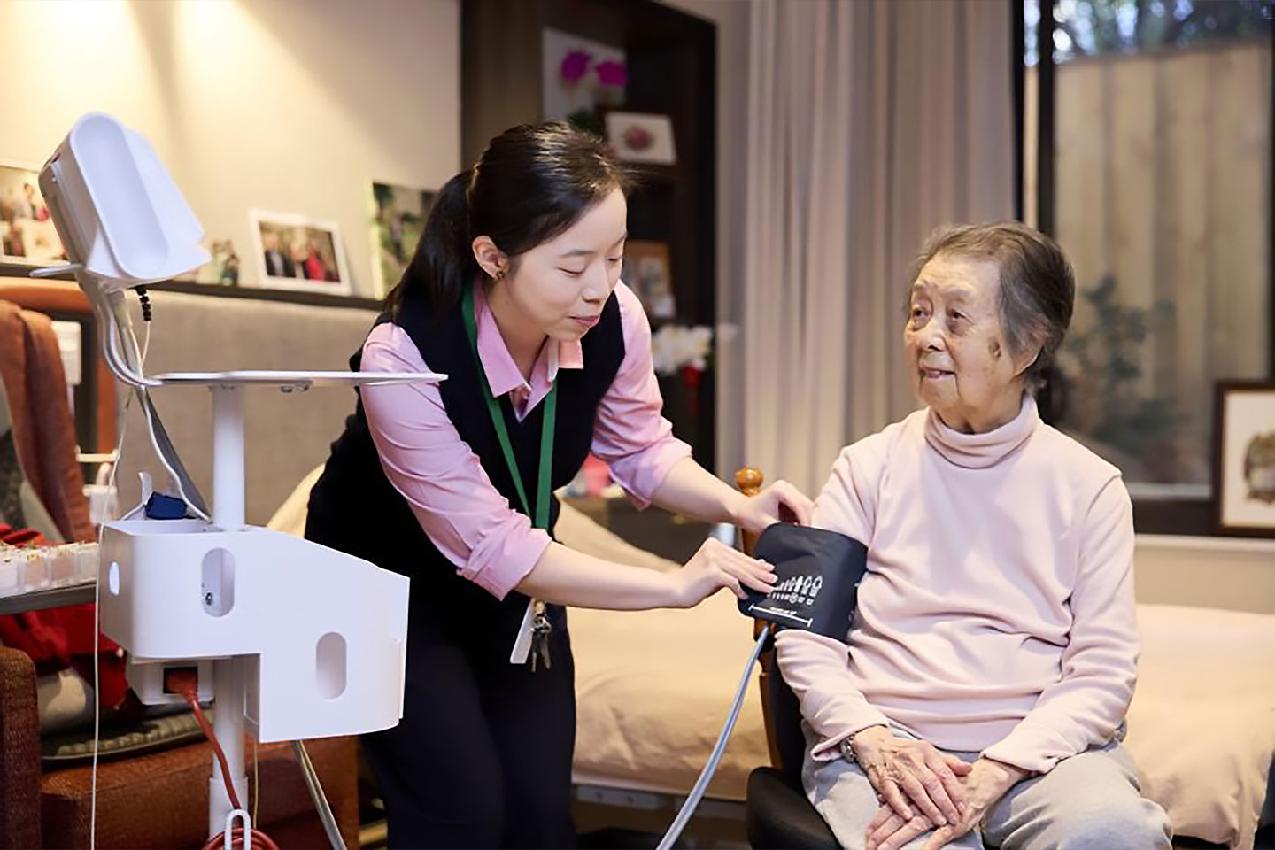 Photo of a health worker taking a patient's blood pressure