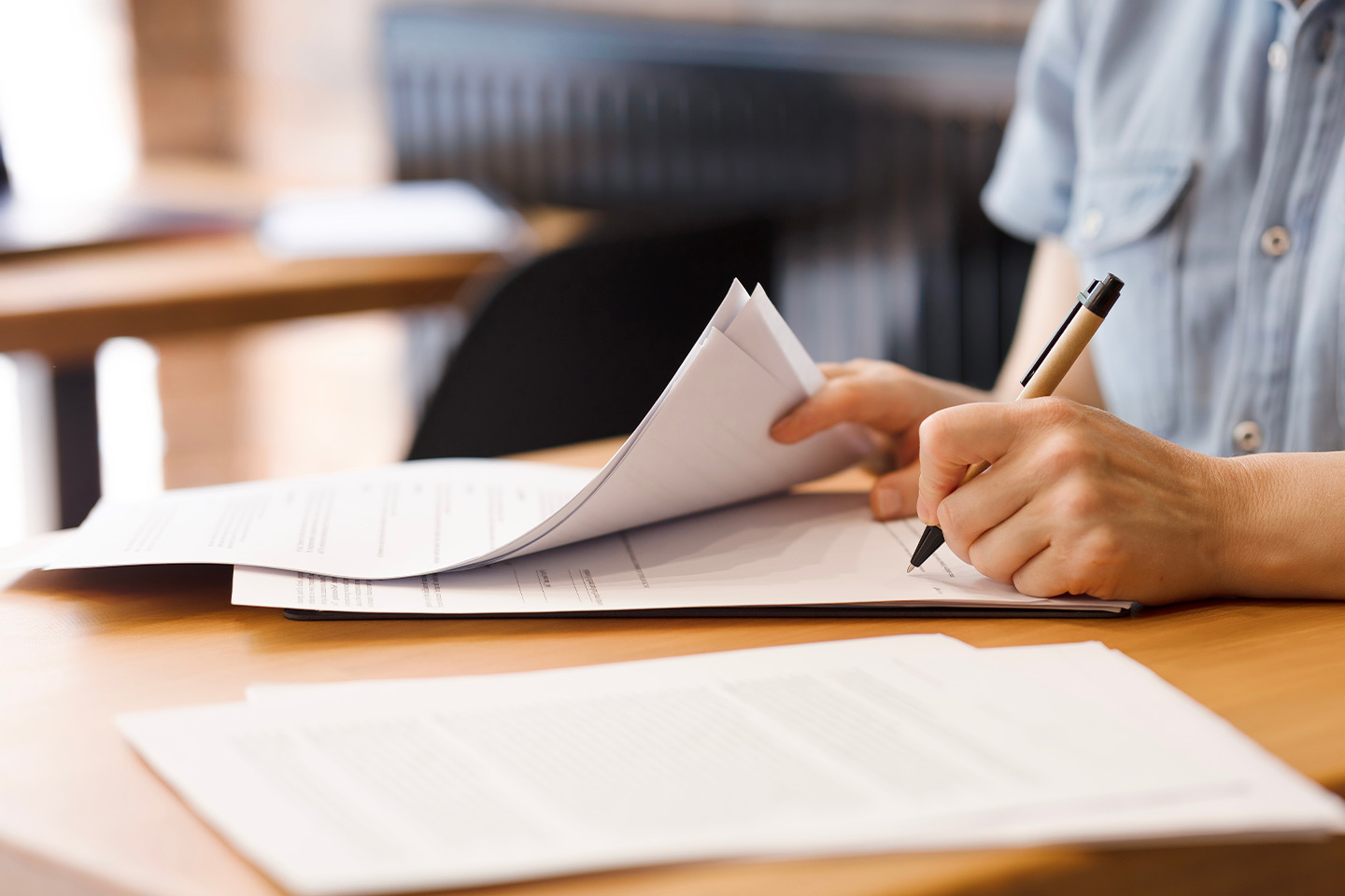 Image of a person signing legal documents