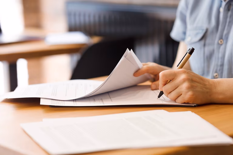 Image of a person signing legal documents