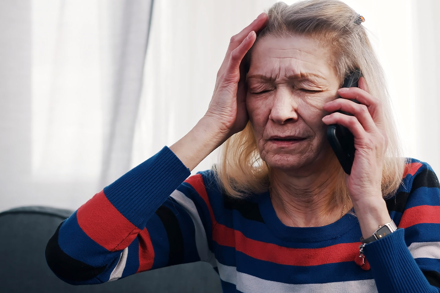 Photo of stressed woman using a mobile phone