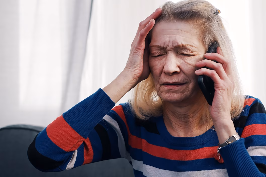 Photo of stressed woman using a mobile phone
