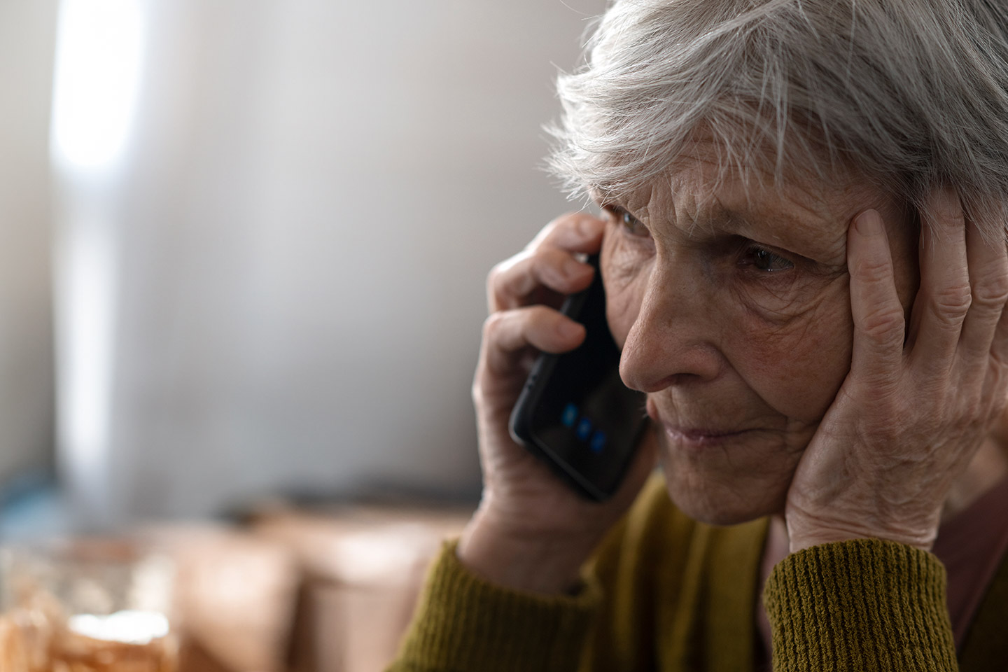 Photo of a woman holding a mobile phone to her ear