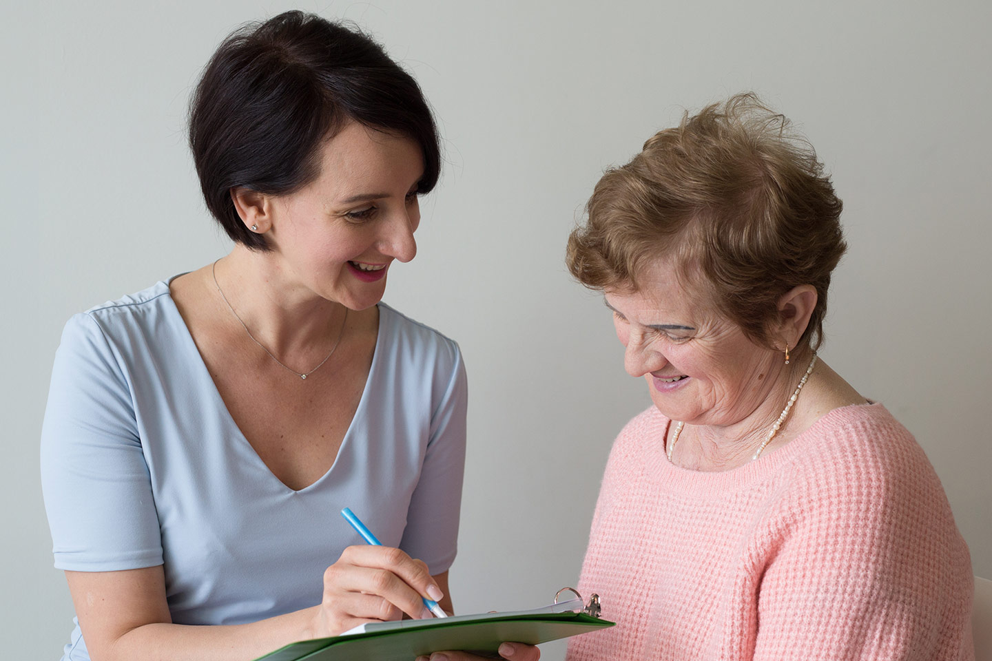 Photo of researcher with a woman in a pale apricot top