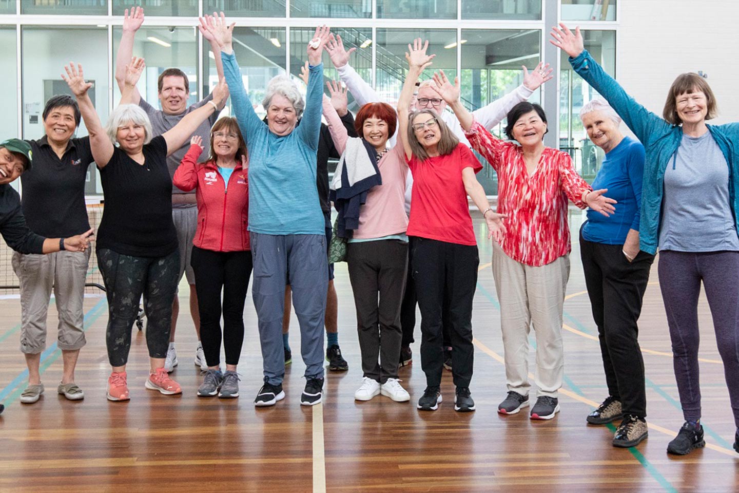 Photo of a group of people cheering with their hands in the air