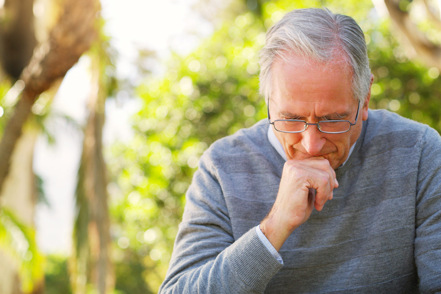 Photo of a man with his chin on his hand