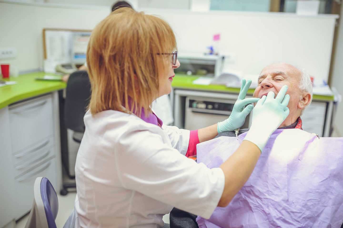 Photo of man have teeth inspected at a dental clinic