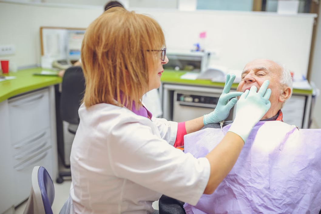 Photo of man have teeth inspected at a dental clinic