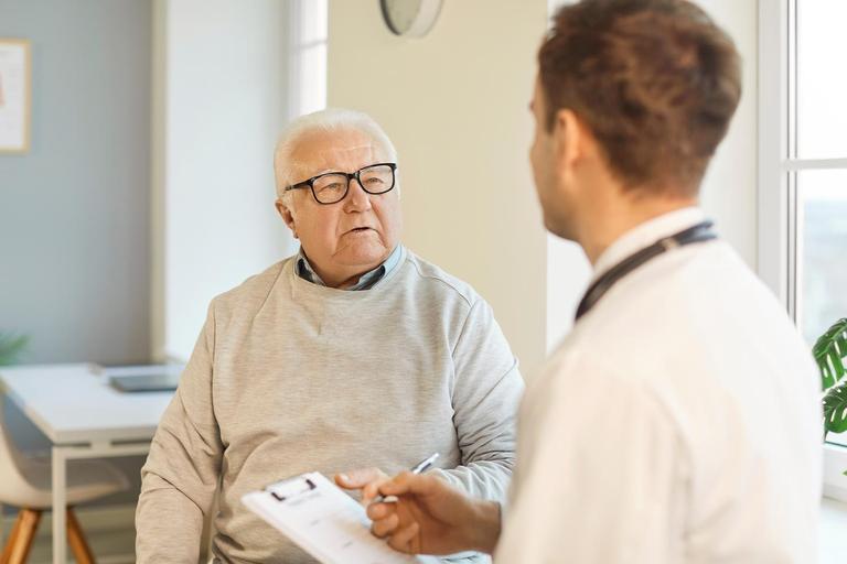Image of an older man and a male service provider