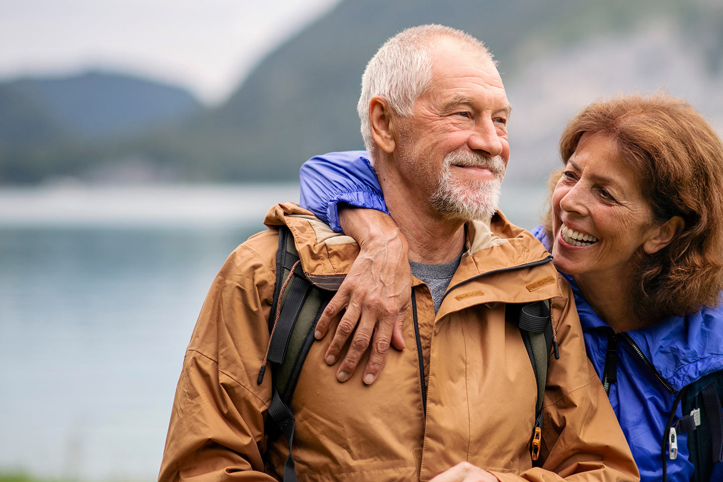 Photo of a couple in smiling in wet weather gear