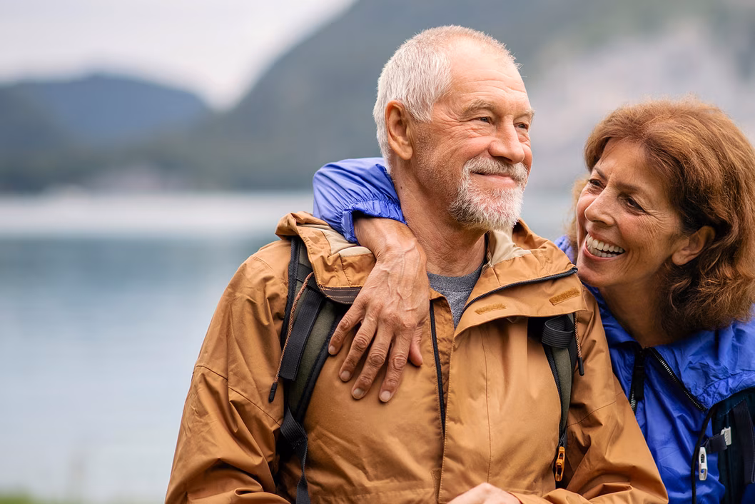 Photo of a couple in smiling in wet weather gear
