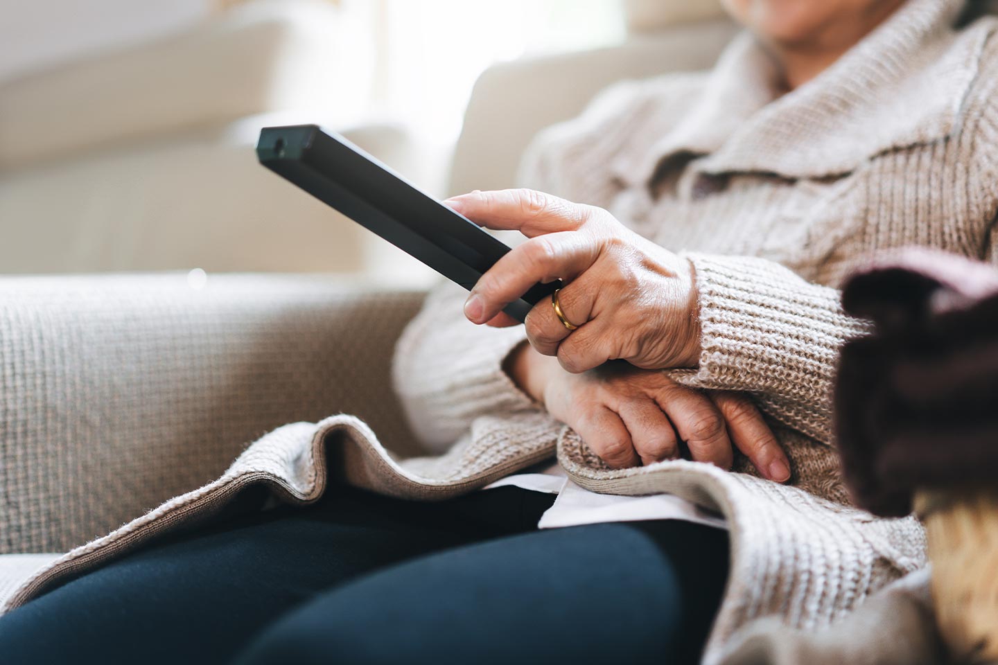 Photo of a hand holding a tv remote