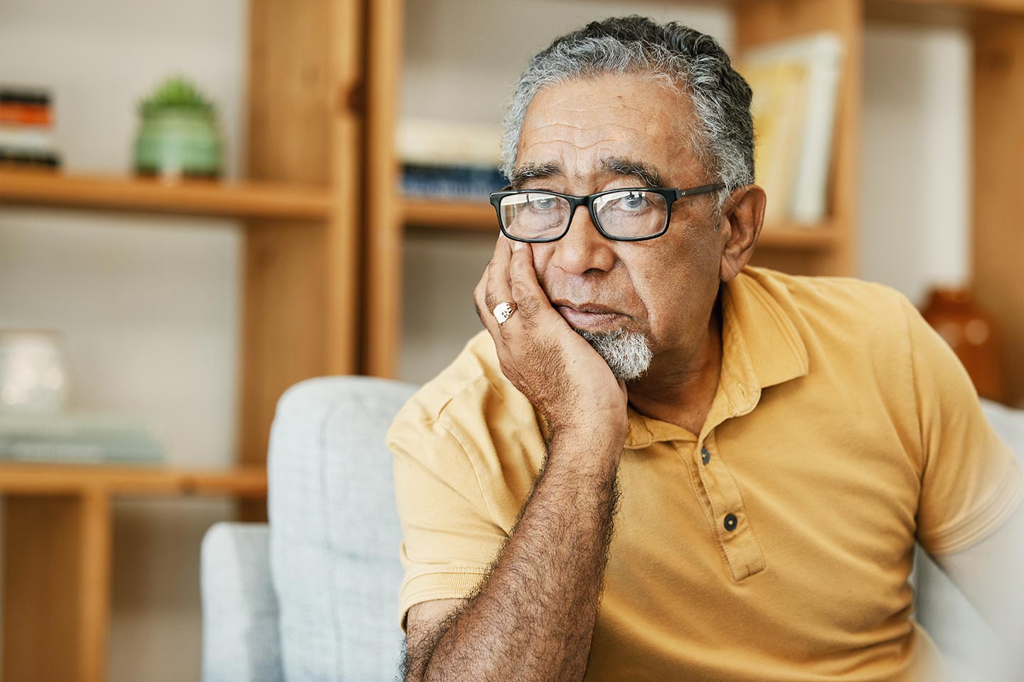 Photo of a man in a yellow polo shirt