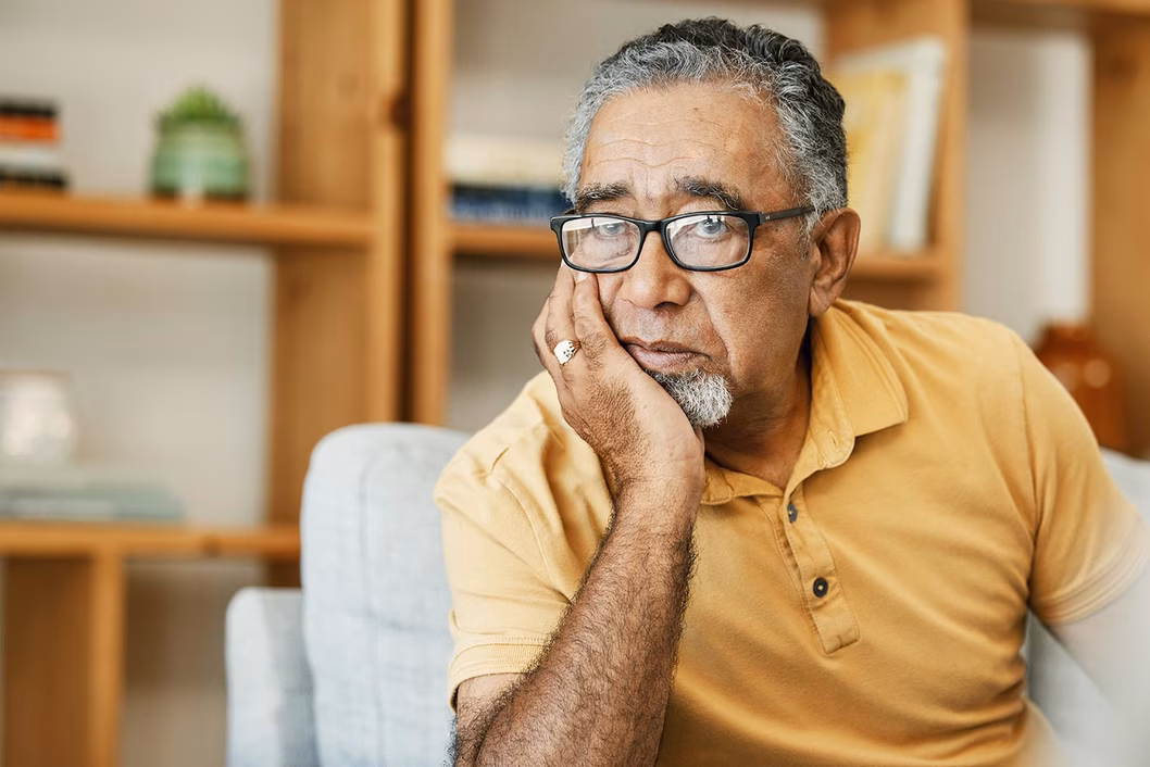 Photo of a man in a yellow polo shirt