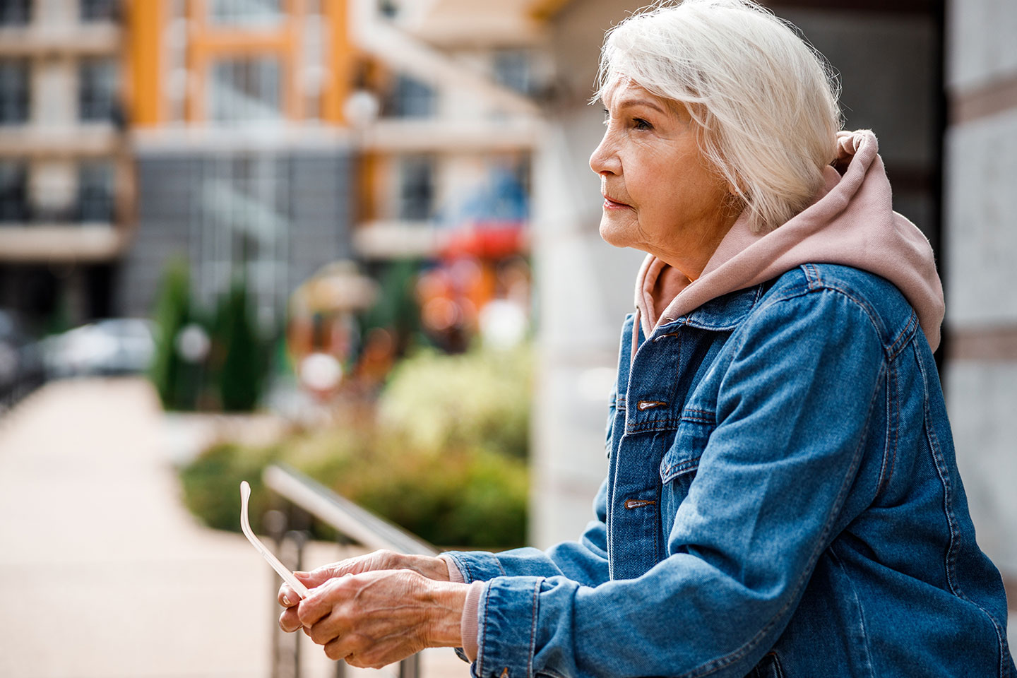 Photo of a women wearing a pink hoodie and denim jacket