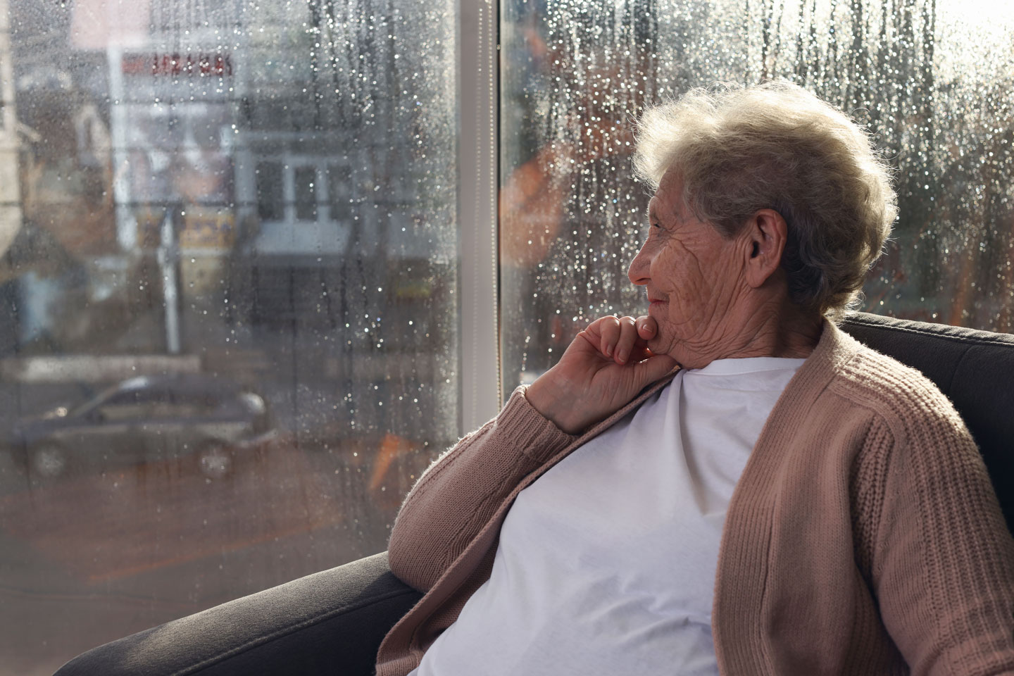 Senior woman looking out the window.