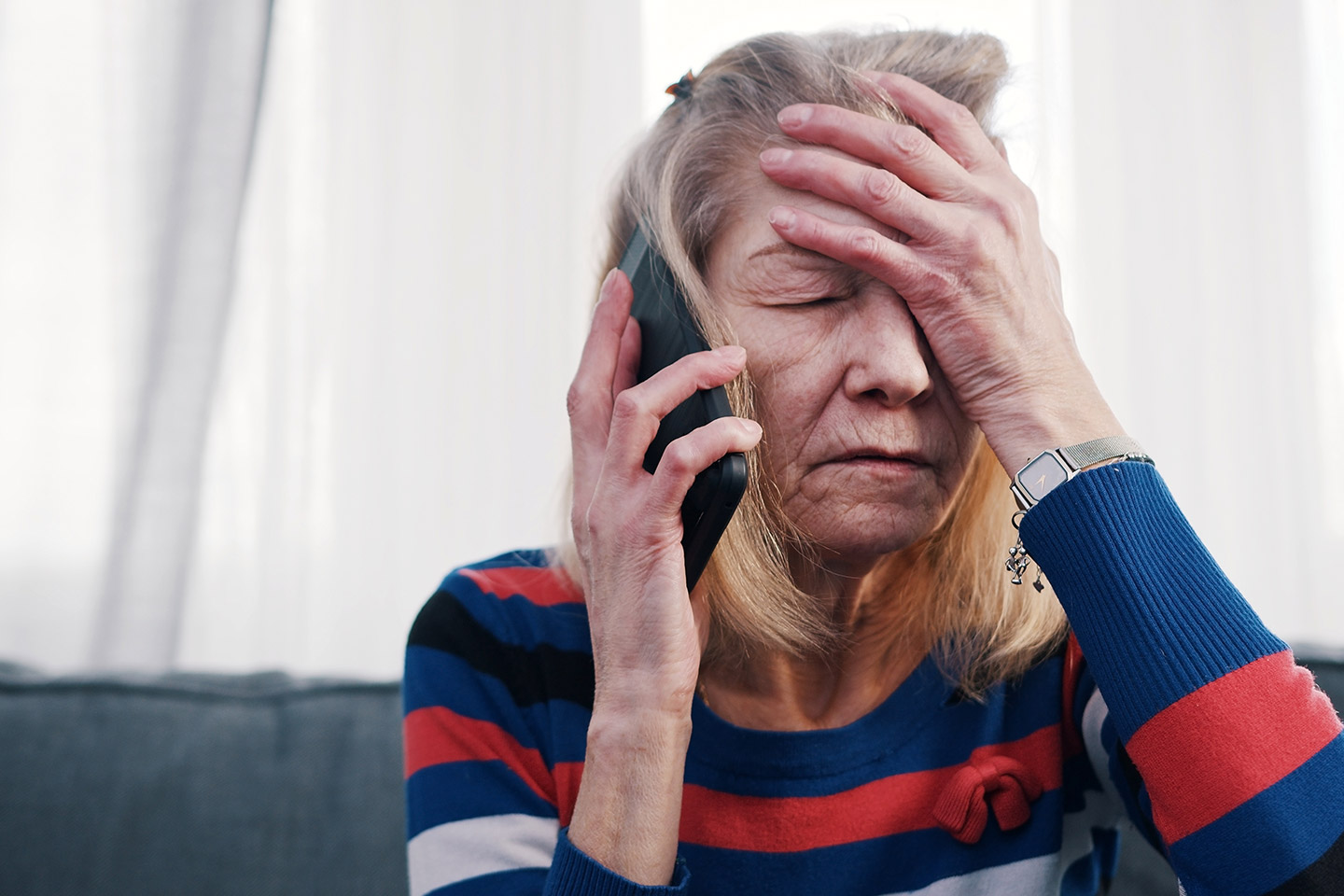 Photo of stressed woman with hand to her forehead