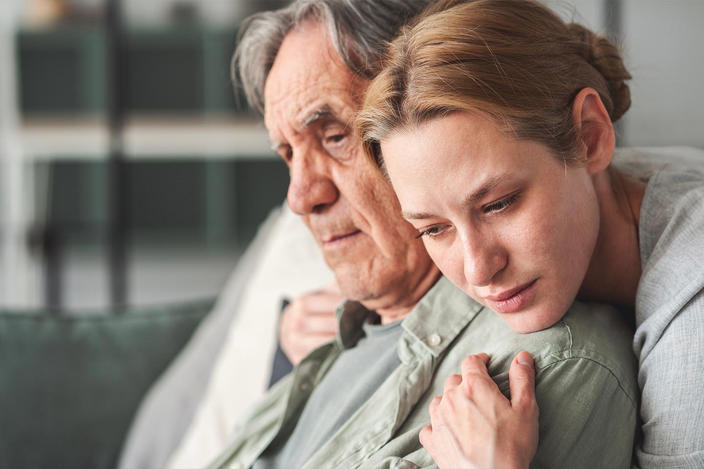 Photo of a young person embracing an older person