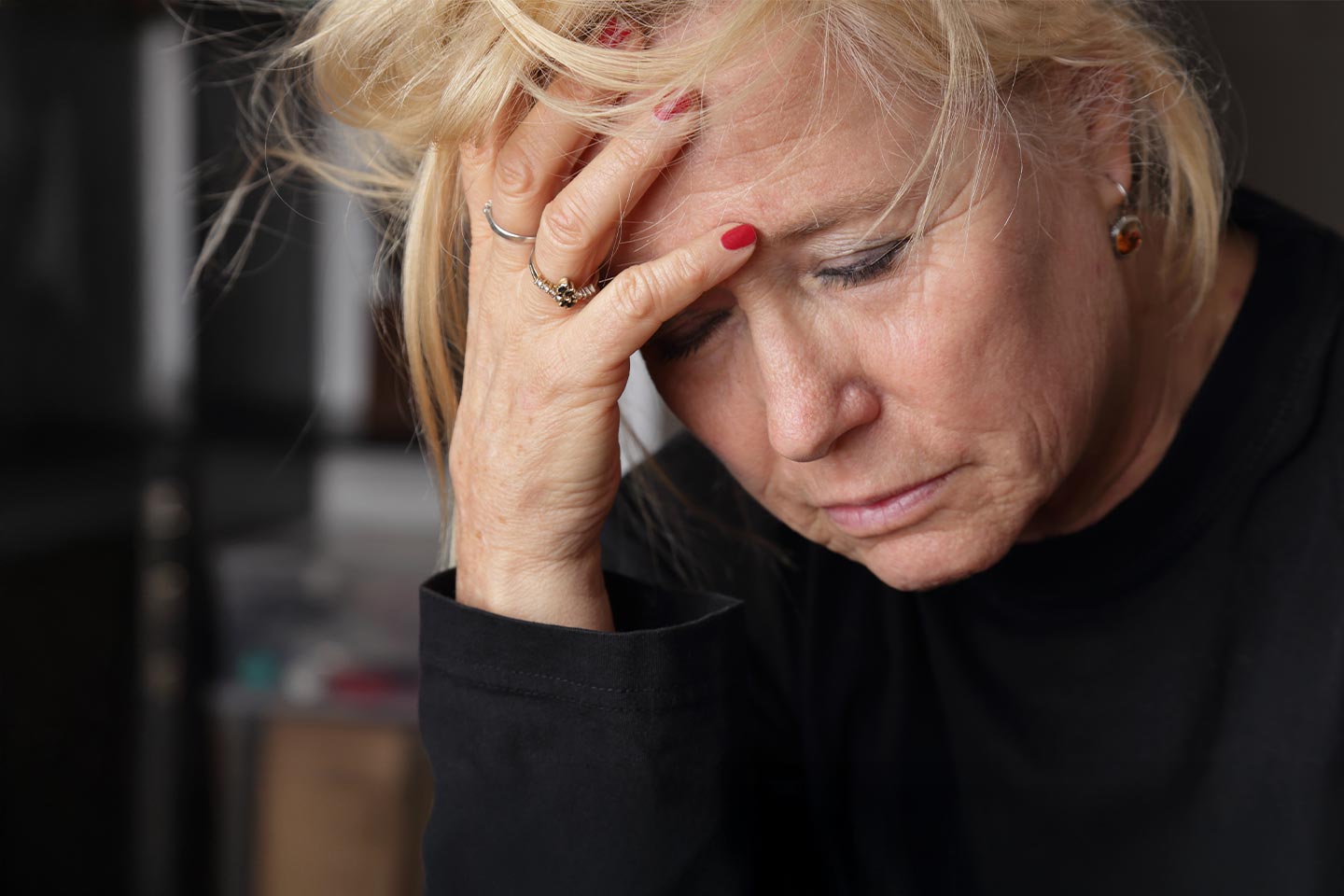 Photo of a woman with her head in her hand