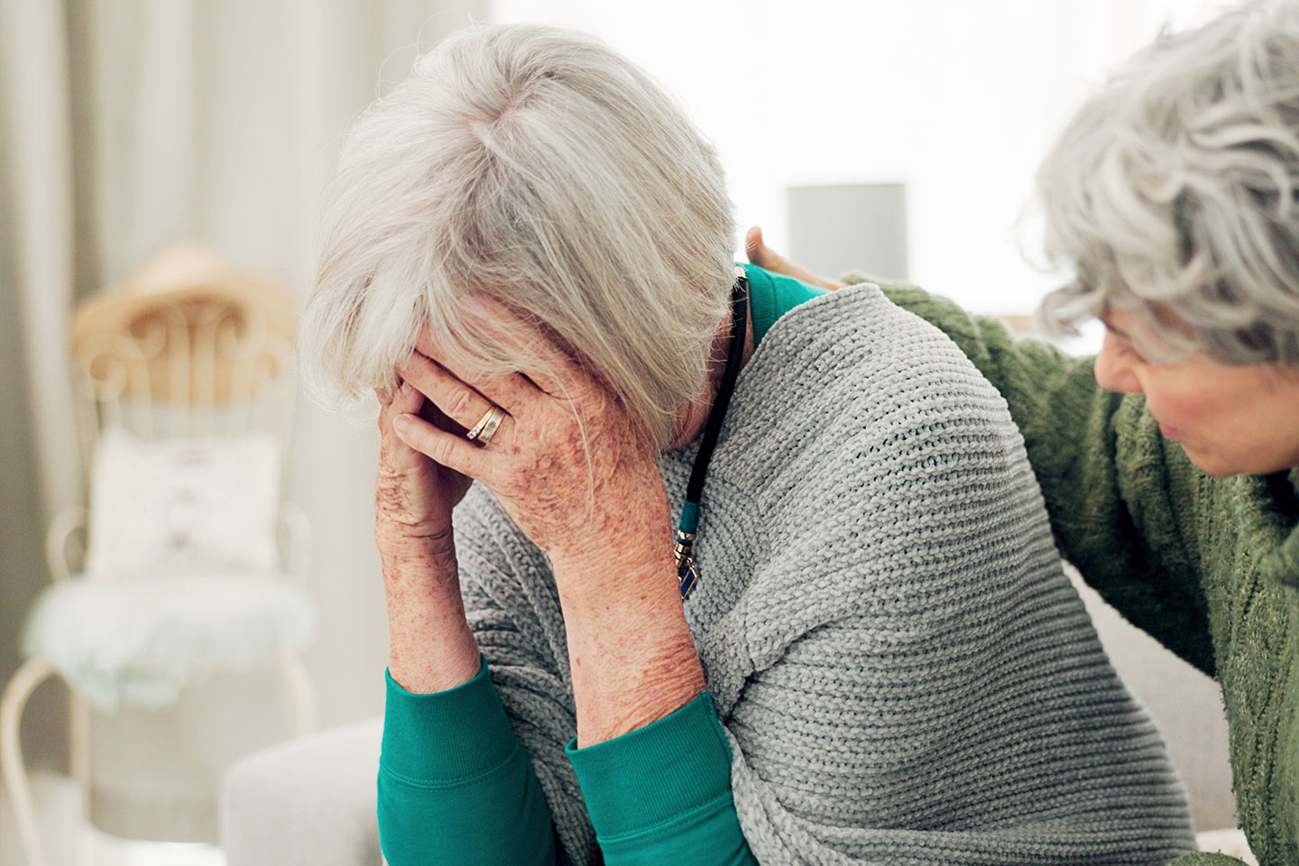 Photo of an upset woman being comforted by a friend