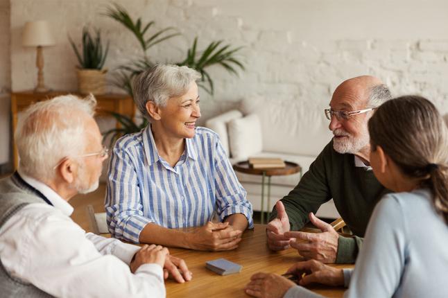 Photo of people sitting at a table smiling