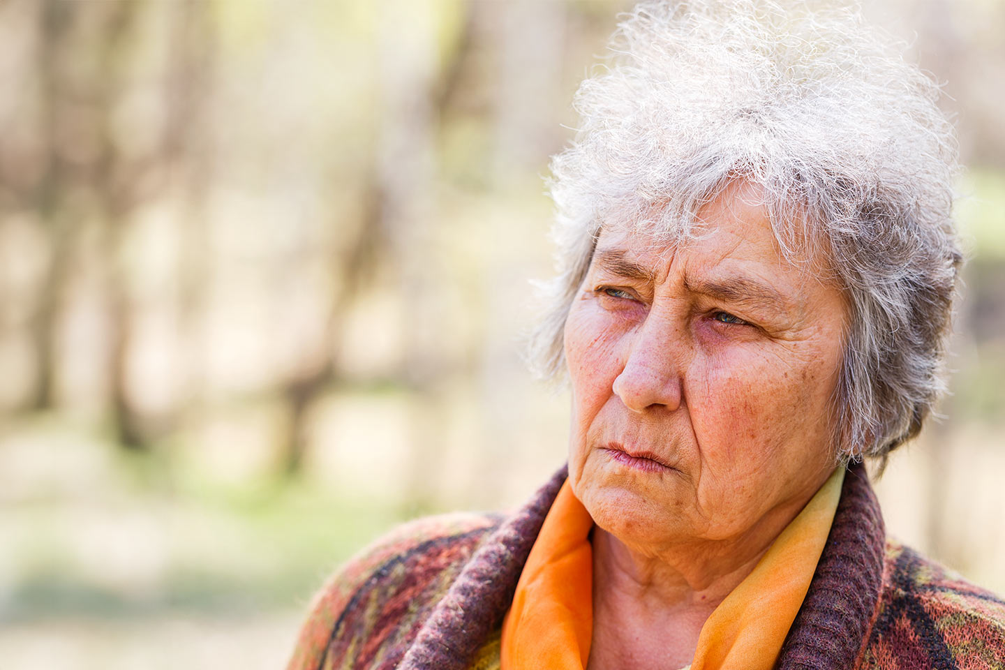 Photo of a woman wearing orange blouse and woolly cardigan